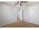 Bedroom with neutral colored walls, with multiple doors and ceiling fan at 5237 Blossom Cv, Lakewood Ranch, FL 34211