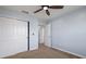 Bedroom with ceiling fan and closet doors, perfect for relaxing after a long day at 5237 Blossom Cv, Lakewood Ranch, FL 34211
