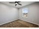 Cozy bedroom with large window for natural light, ceiling fan, and neutral walls at 5237 Blossom Cv, Lakewood Ranch, FL 34211