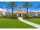 Community clubhouse surrounded by lush landscaping and palm trees, offering residents a gathering space at 5237 Blossom Cv, Lakewood Ranch, FL 34211