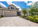 Charming two-story home showcasing a well-manicured lawn and a paved driveway leading to a two-car garage at 5237 Blossom Cv, Lakewood Ranch, FL 34211