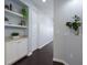 Stylish hallway featuring dark wood floors, built-in shelving, and fresh, neutral paint at 5237 Blossom Cv, Lakewood Ranch, FL 34211