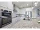 Bright, modern kitchen with a center island, granite countertops, and stainless steel appliances at 5237 Blossom Cv, Lakewood Ranch, FL 34211