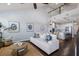 Spacious living room open to kitchen with modern decor, high ceilings, and dark wood floors at 5237 Blossom Cv, Lakewood Ranch, FL 34211