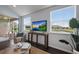 Comfortable living room with dark floors and view to the covered porch and lake at 5237 Blossom Cv, Lakewood Ranch, FL 34211