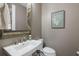 Charming powder room featuring a decorative mirror, stylish vanity, and modern fixtures at 5237 Blossom Cv, Lakewood Ranch, FL 34211