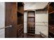 Spacious walk-in closet featuring custom wood shelving and ample storage space for clothes and accessories at 5237 Blossom Cv, Lakewood Ranch, FL 34211