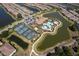 A community aerial view highlights many amenities including tennis courts, lakes, a resort style pool, and clubhouse at 5301 Bartolomeo St, Sarasota, FL 34238