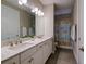Bright bathroom with double sinks, stone countertops, and tiled shower/tub combo at 5301 Bartolomeo St, Sarasota, FL 34238