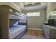 Comfortable bedroom boasts unique bunk beds and an array of gray furnishings at 5301 Bartolomeo St, Sarasota, FL 34238