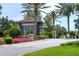View of the community entrance with stone gatehouse, paver drive and manicured landscaping at 5301 Bartolomeo St, Sarasota, FL 34238