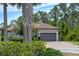 Charming home featuring a tile roof, paved driveway and an attached two car garage at 5301 Bartolomeo St, Sarasota, FL 34238