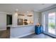 Bright kitchen with white cabinets, stainless steel appliances, and a breakfast bar overlooking the living room at 5301 Bartolomeo St, Sarasota, FL 34238