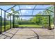 Outdoor lanai featuring a brick patio, screened enclosure, and view of the landscaped backyard at 5301 Bartolomeo St, Sarasota, FL 34238
