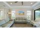 Bright living room features neutral walls, tray ceiling, ceiling fan, and comfortable seating at 5301 Bartolomeo St, Sarasota, FL 34238