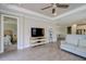 Open-concept living room with ceiling fan flowing to the bedroom and kitchen areas at 5301 Bartolomeo St, Sarasota, FL 34238
