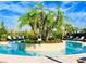 Inviting pool with a unique island feature with lush tropical landscaping and inviting lounge chairs at 5301 Bartolomeo St, Sarasota, FL 34238