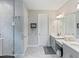 Modern bathroom features double vanity, decorative mirror, and glass-enclosed shower at 5406 Limelight Dr, Apollo Beach, FL 33572