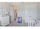 Bright bedroom featuring decor for a young girl, including a dresser, clothes rack, and framed wall art at 5406 Limelight Dr, Apollo Beach, FL 33572