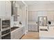 Modern kitchen with stainless steel appliances, gray cabinets, and quartz countertops at 5406 Limelight Dr, Apollo Beach, FL 33572