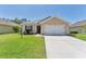 Charming single-story home with well-manicured lawn and two-car garage at 5717 71St E St, Palmetto, FL 34221