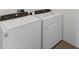 Laundry room featuring white Whirlpool washer and dryer at 5717 71St E St, Palmetto, FL 34221