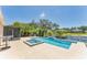 Backyard pool with hot tub overlooking beautiful lake view and lush landscaping at 5717 71St E St, Palmetto, FL 34221
