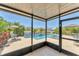 Screened in patio with a pool, hot tub and furniture overlooking the lake at 5717 71St E St, Palmetto, FL 34221