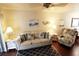 Inviting living room with wood floors, a sliding door to a balcony, and a comfortable seating area at 5877 17Th W St # B4, Bradenton, FL 34207