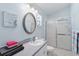 Bathroom featuring modern fixtures, a large oval mirror, and a glass-enclosed shower at 5909 33Rd E Dr, Palmetto, FL 34221