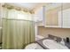 Bathroom with a vanity, toilet, and shower with green curtain at 5909 33Rd E Dr, Palmetto, FL 34221