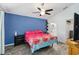 Bedroom with vaulted ceiling, ceiling fan, wood-look floors, blue accent wall, and en-suite bathroom access at 5909 33Rd E Dr, Palmetto, FL 34221