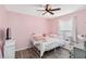 Pink bedroom with luxury vinyl floors, a ceiling fan, and a bright window at 5909 33Rd E Dr, Palmetto, FL 34221