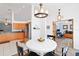 Bright dining area with modern lighting fixture, open to kitchen at 5909 33Rd E Dr, Palmetto, FL 34221