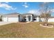 Charming single-story home with a three-car garage, green trim, and landscaped yard at 5909 33Rd E Dr, Palmetto, FL 34221