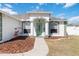 Inviting front entrance with green door, pillars, and lush landscaping at 5909 33Rd E Dr, Palmetto, FL 34221