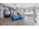 Cozy living room with a blue velvet couch and sliding doors at 5909 33Rd E Dr, Palmetto, FL 34221