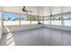 Enclosed sunroom featuring two ceiling fans, paneled walls, and views of the backyard at 5909 33Rd E Dr, Palmetto, FL 34221