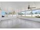 Enclosed sunroom featuring two ceiling fans, paneled walls, and views of the fenced-in backyard at 5909 33Rd E Dr, Palmetto, FL 34221