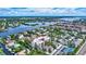 Scenic aerial view of the condos, lush landscaping, and surrounding waterways at 6157 Midnight Pass Rd # E65, Sarasota, FL 34242