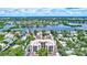 Stunning aerial view of waterfront homes, mature trees and water in a beautiful community at 6157 Midnight Pass Rd # E65, Sarasota, FL 34242