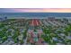 Stunning aerial view of a beachfront community featuring a pool, lush greenery, and convenient beach access at 6157 Midnight Pass Rd # E65, Sarasota, FL 34242