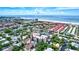 Aerial view showcasing the condos, pool, nearby beach, and coastal setting at 6157 Midnight Pass Rd # E65, Sarasota, FL 34242