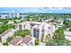 An aerial showcasing lush landscaping and the building's prime waterfront location at 6157 Midnight Pass Rd # E65, Sarasota, FL 34242