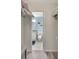 En suite bathroom with walk in closet and tile floor at 6157 Midnight Pass Rd # E65, Sarasota, FL 34242