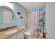 Bright bathroom featuring a granite countertop and tub/shower combo at 6157 Midnight Pass Rd # E65, Sarasota, FL 34242