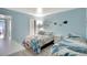 Comfortable bedroom featuring twin beds, coastal decor, and ample space for rest and relaxation at 6157 Midnight Pass Rd # E65, Sarasota, FL 34242