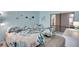 Serene bedroom featuring twin beds, coastal decor, and plenty of natural light from a nearby window at 6157 Midnight Pass Rd # E65, Sarasota, FL 34242