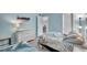 Inviting bedroom with twin beds, dresser, coastal decor, and closet; providing comfortable accommodations at 6157 Midnight Pass Rd # E65, Sarasota, FL 34242