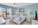 Bedroom featuring a king bed, ceiling fan, and large sunny windows at 6157 Midnight Pass Rd # E65, Sarasota, FL 34242